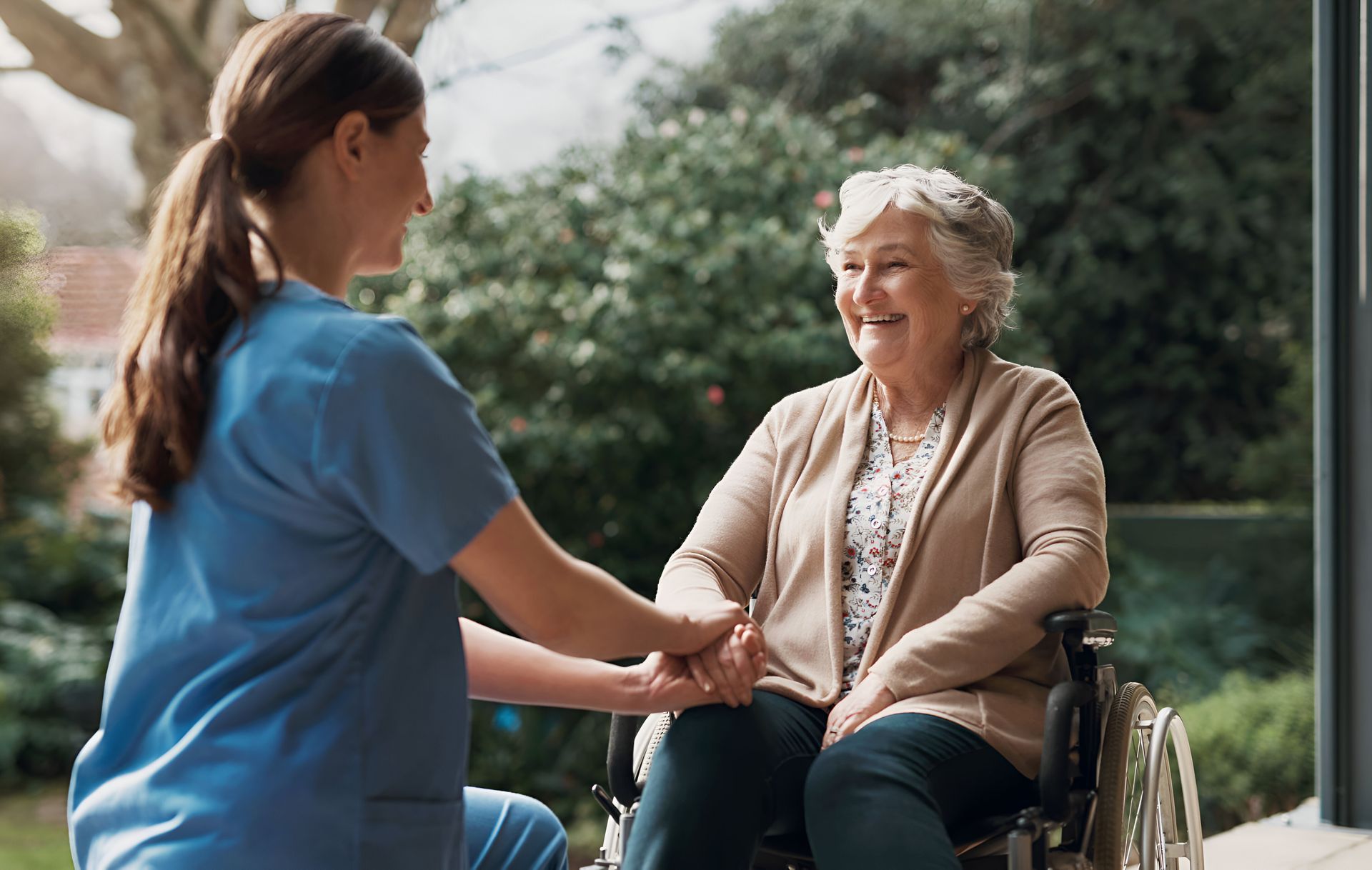 Nurse supporting a senior in a wheelchair
